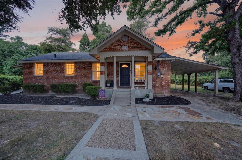 810 Edna Street Athens, TX 75751 - Photo 1 of 28 Brick exterior with a covered carport, mature trees, and a concrete walkway