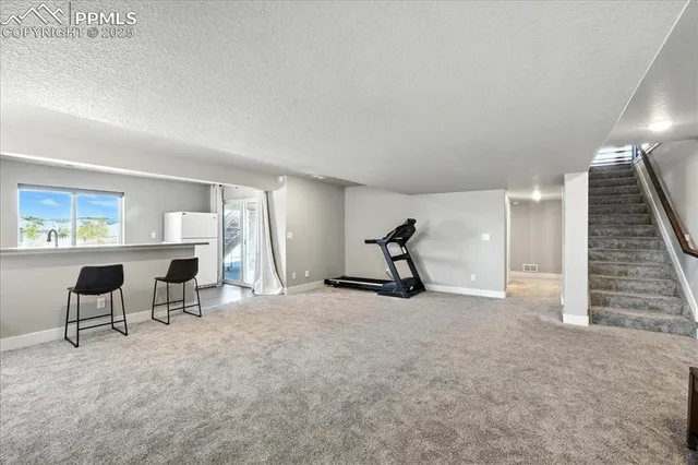 a view of a livingroom with furniture and a window