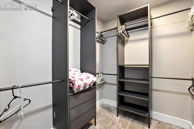 a storage room with water heater and wooden cabinets