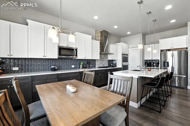 a large kitchen with a table and chairs