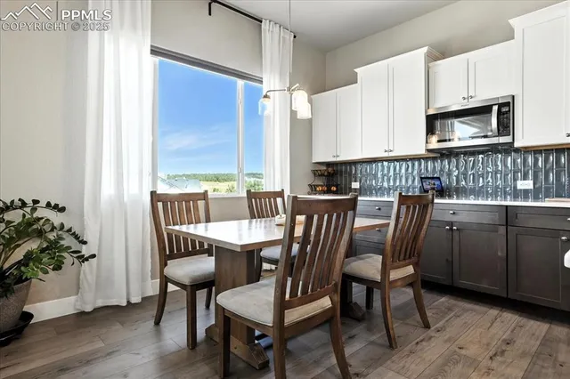 a view of a dining room with furniture and wooden floor