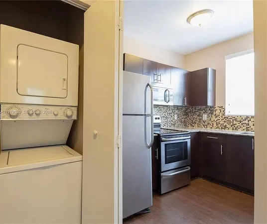 a kitchen with a refrigerator and a sink