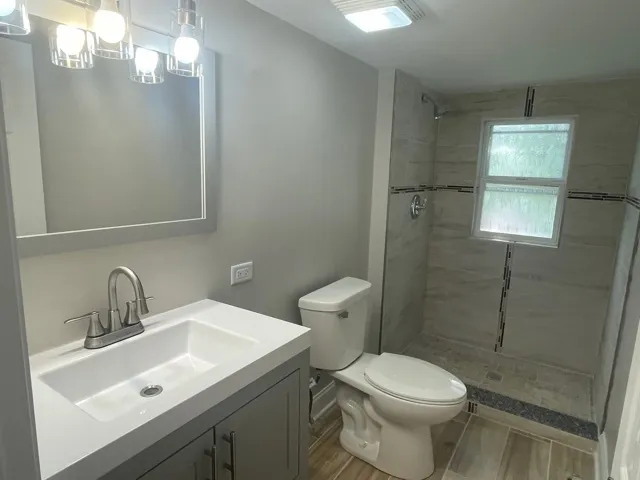 a bathroom with a sink toilet and shower