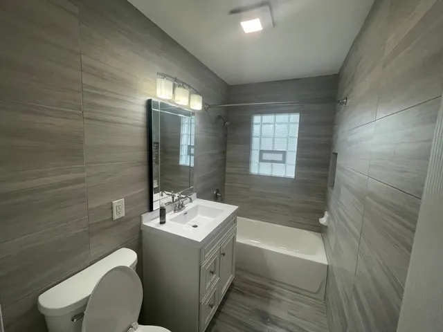 a bathroom with a sink a toilet and bathtub