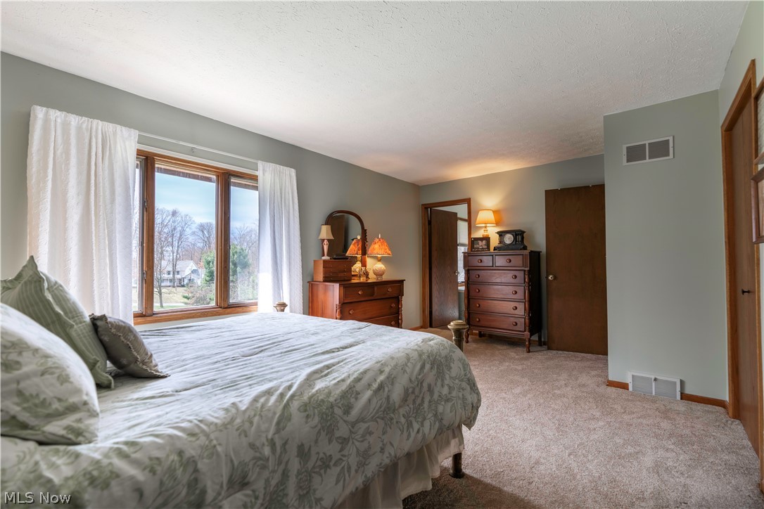 585 Yager Road Clinton, OH 44216 - Photo 23 of 35 Bedroom with carpet and a textured ceiling