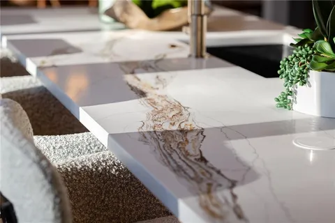a kitchen with a large window sink and cabinets