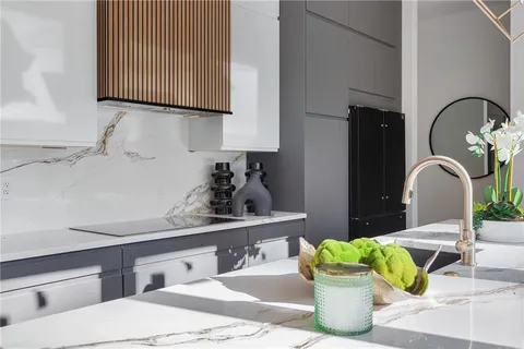 a kitchen with a sink and lots of wooden cabinets