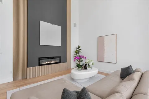 a living room with furniture and flowers