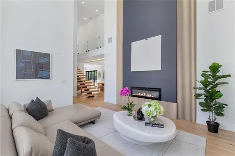a living room with furniture and a potted plant