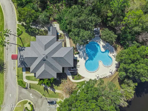 an aerial view of a house with yard swimming pool and outdoor seating