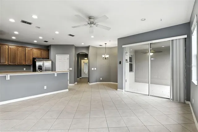 a view of a kitchen with a sink and a refrigerator
