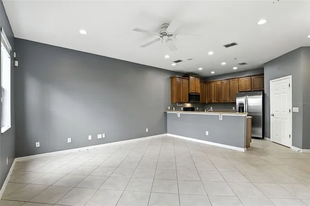 a view of kitchen with a sink and refrigerator