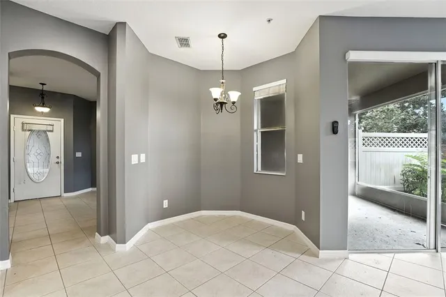 a view of a hallway with chandelier and entryway
