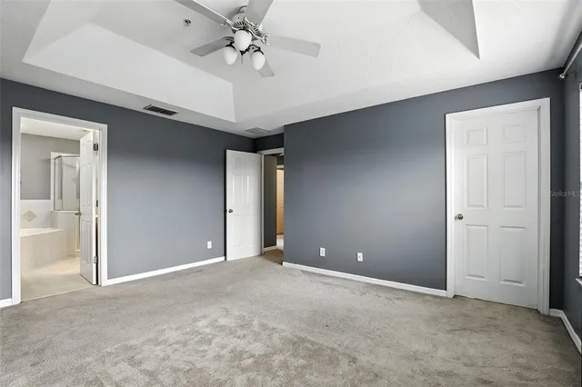a view of an empty room with a fan