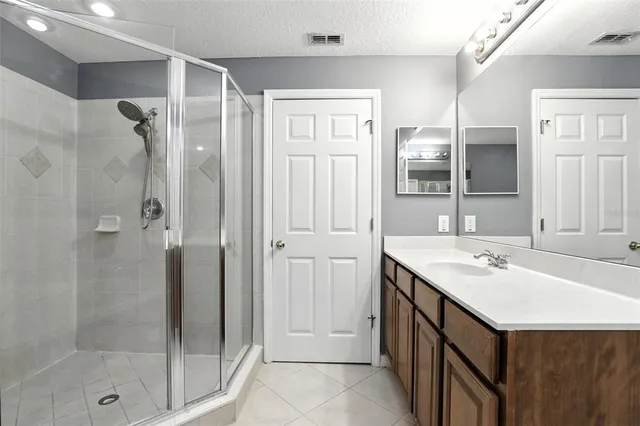 a bathroom with a shower sink and mirror