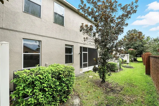 a front view of a house with a garden and trees