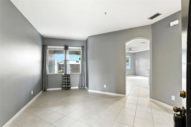 an empty room with windows and entrance