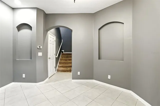 a view of a livingroom with wooden floor and stairs