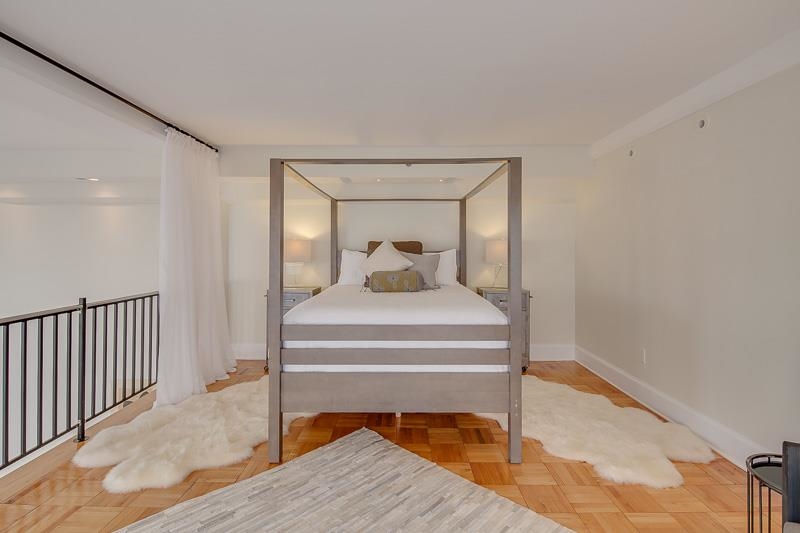 97 Monroe Avenue Memphis, TN 38103 - Photo 17 of 25 a bedroom with a bed and wooden floor