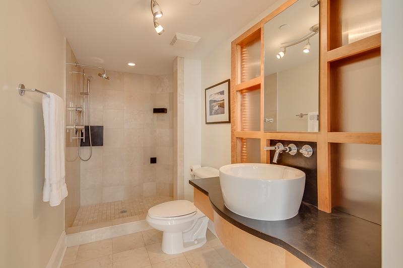 97 Monroe Avenue Memphis, TN 38103 - Photo 6 of 25 a bathroom with a toilet a sink and a large mirror