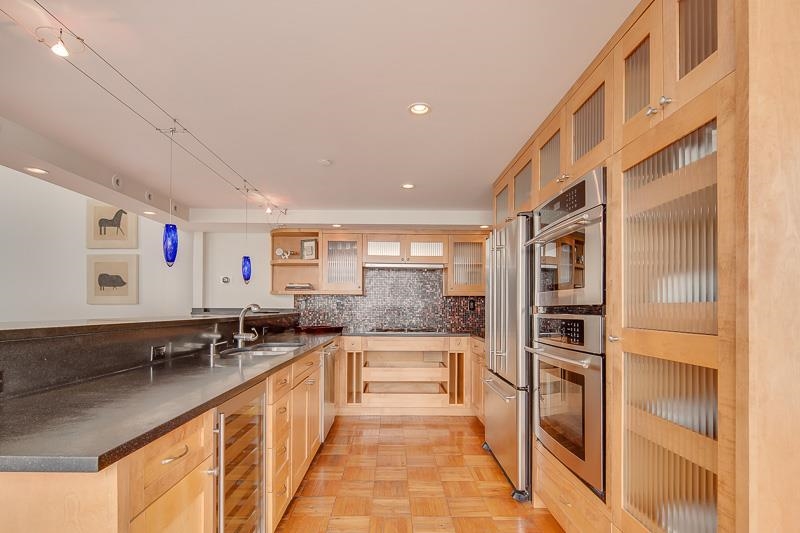 97 Monroe Avenue Memphis, TN 38103 - Photo 8 of 25 a large white kitchen with a lot of counter space and glass door