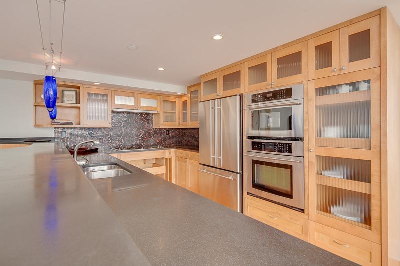 97 Monroe Avenue Memphis, TN 38103 - Photo 10 of 25 a kitchen with stainless steel appliances granite countertop a refrigerator and a stove top oven