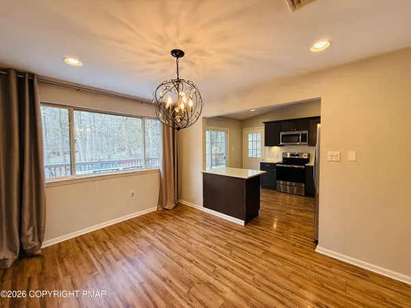 a view of kitchen and dining room with wooden floor