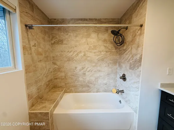 a bathroom with a shower and a bathtub