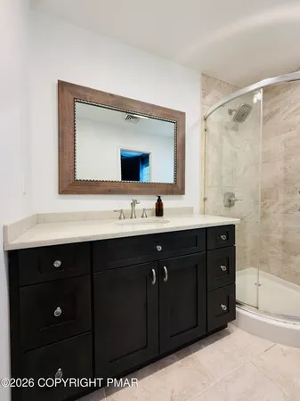 a bathroom with a sink vanity and mirror