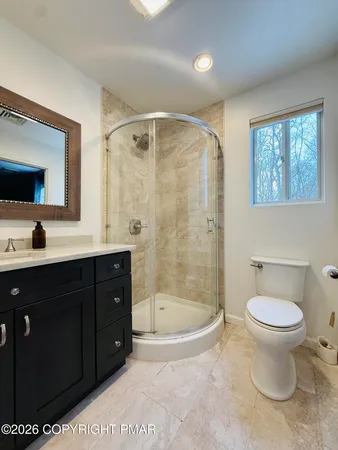 a bathroom with a sink toilet and shower
