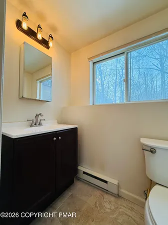 a bathroom with a sink a toilet and mirror