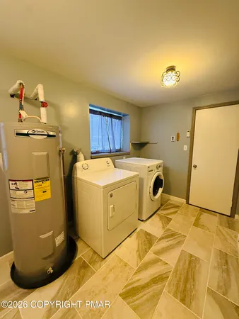 a utility room with a washer dryer and washer