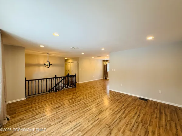 a view of a room with wooden floor