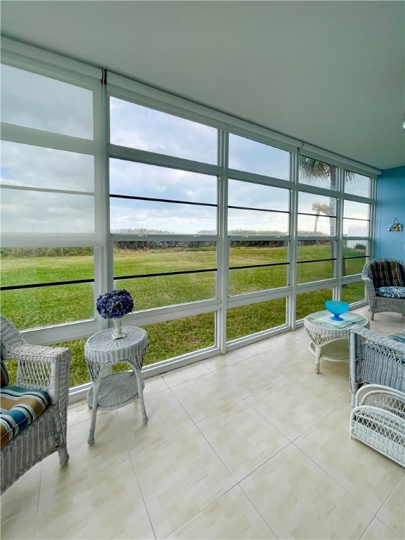 5400 A1a Highway, Unit A2 Vero Beach, FL 32963 - Photo 8 of 28 a view of a chair and tables in the porch
