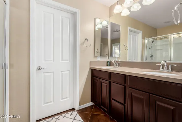 a bathroom with a double vanity sink and a mirror