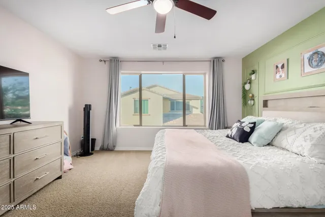 a bedroom with a large bed and a chandelier