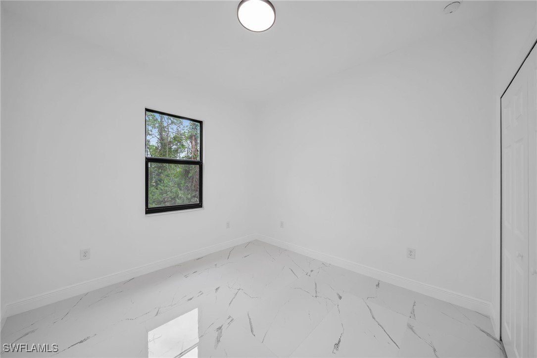 1006 West 10th Street Lehigh Acres, FL 33972 - Photo 21 of 32 an empty room with a window