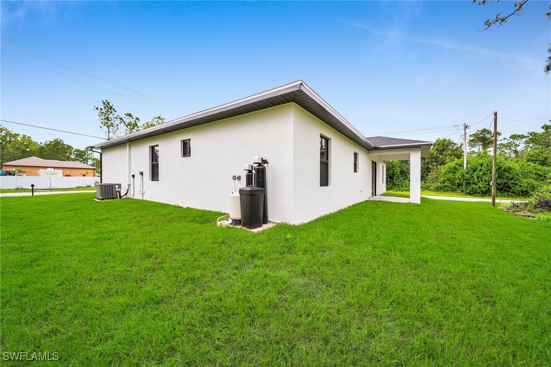 1006 West 10th Street Lehigh Acres, FL 33972 - Photo 28 of 32 a view of a house with backyard