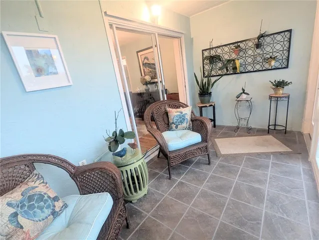 a living room with furniture and a painting on the wall