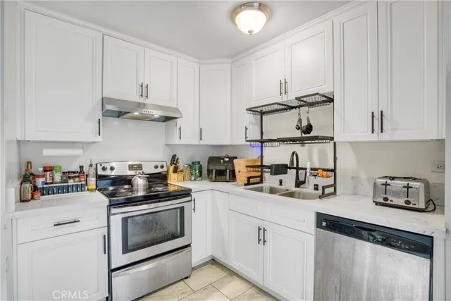 a kitchen with white cabinets and white appliances