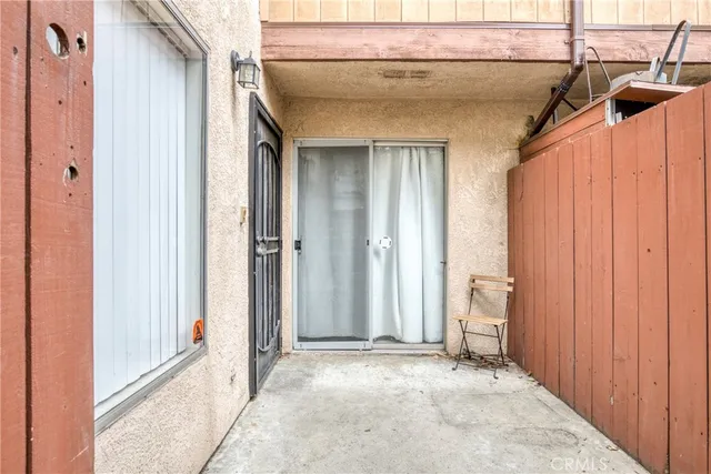 a view of a door and chair in the balcony