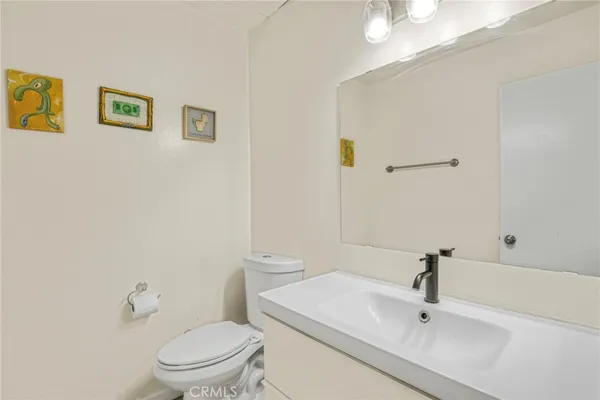 a white toilet sitting next to a bathroom sink