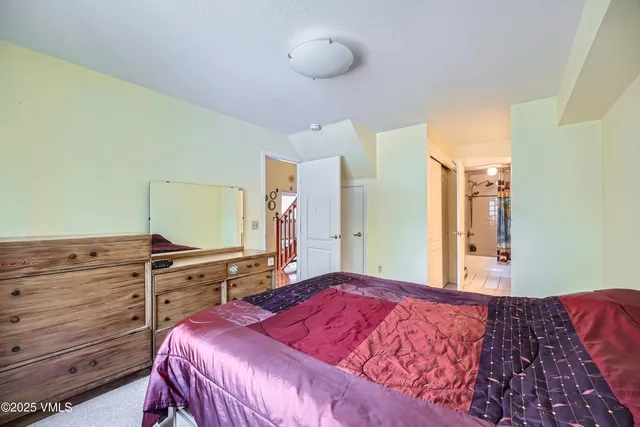 a bedroom with a bed and cabinets