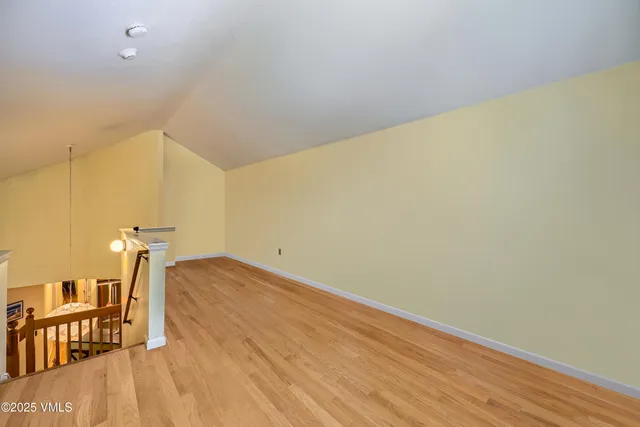 a view of a room with wooden floor