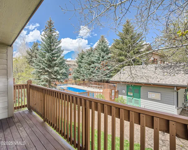 a view of a balcony with wooden fence