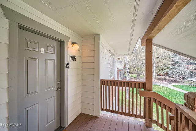 a view of a porch with wooden floor and stairs