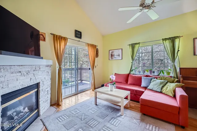 a living room with furniture and a fireplace