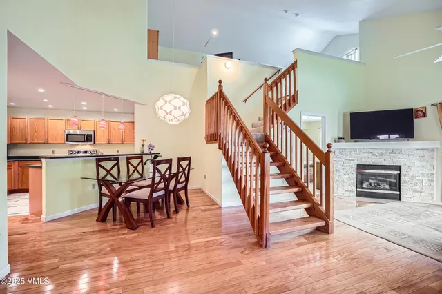 a dining room with furniture entryway and wooden floor