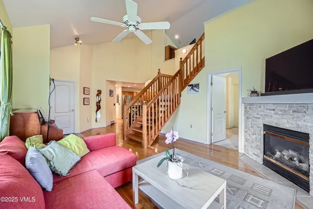 a living room with furniture a flat screen tv and a fireplace