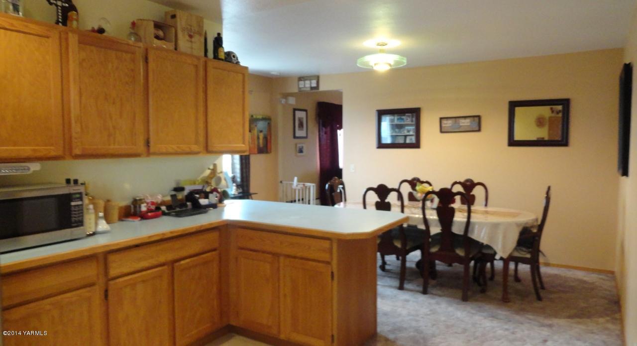 3551 McDonald Road Wapato, WA 98951 - Photo 3 of 10 a kitchen with a sink cabinets and dining table